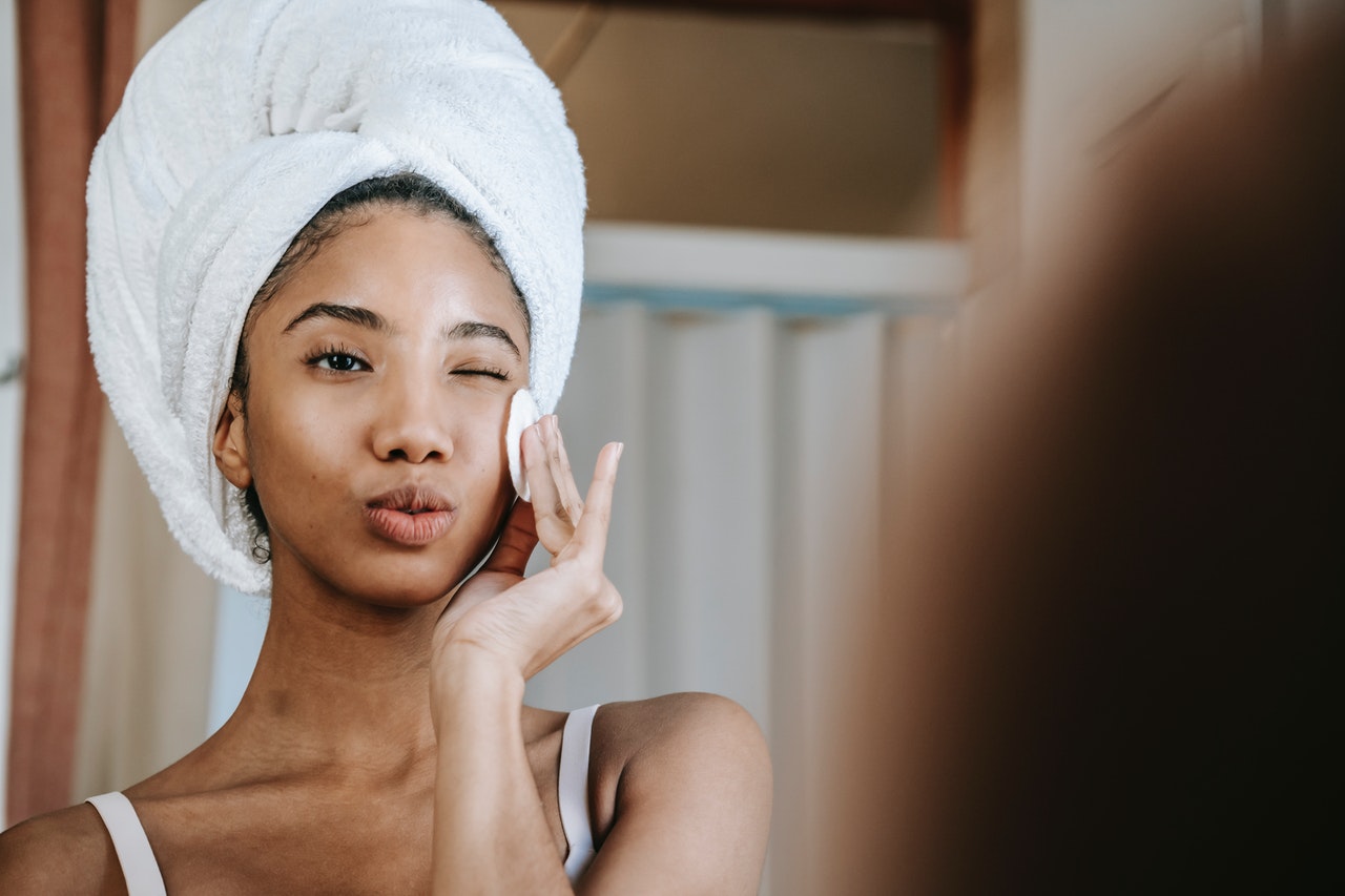 Woman is removing her make up to prevent pimples