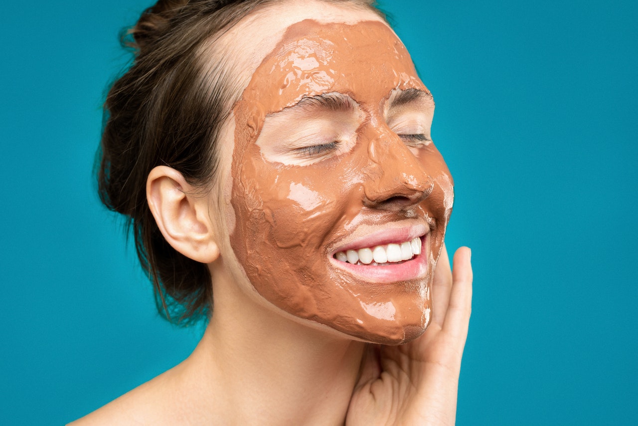 Woman does her skin care with use of caffeine skincare product