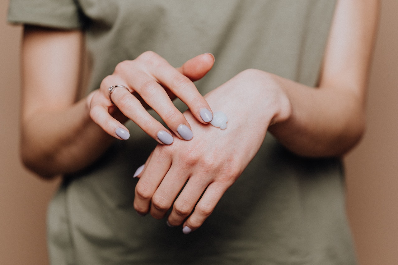 Woman is using moisturizer